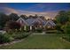 Charming brick home with manicured lawn, elegant landscaping and soft evening light at 1005 Cromwell Cv, Snellville, GA 30078