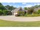 Side view of charming brick home with lush landscaping, a wide driveway and a two-car garage at 1005 Cromwell Cv, Snellville, GA 30078