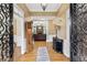 Elegant foyer with hardwood floors, decorative iron doors and view into the living room at 1005 Cromwell Cv, Snellville, GA 30078