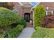 Charming front entrance with beautiful brickwork and lush landscaping at 1005 Cromwell Cv, Snellville, GA 30078