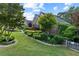 Charming brick home with manicured lawn, rock borders, and diverse greenery in a well-maintained front yard at 1005 Cromwell Cv, Snellville, GA 30078