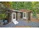 Backyard greenhouse with double doors and gravel landscaping at 1005 Cromwell Cv, Snellville, GA 30078