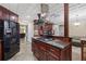 Stylish kitchen with stainless steel appliances, granite counters, and dark wood cabinets at 1005 Cromwell Cv, Snellville, GA 30078