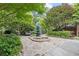 Lush backyard featuring stone pathway, decorative rocks, and diverse plant life at 1005 Cromwell Cv, Snellville, GA 30078