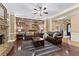 Comfortable living room with a stone fireplace, floating shelves and crown molding for a cozy and inviting atmosphere at 1005 Cromwell Cv, Snellville, GA 30078