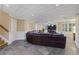 Spacious living room featuring a large leather sectional and tile floors at 1005 Cromwell Cv, Snellville, GA 30078