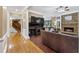 Spacious living room with hardwood floors, stone fireplace, built-in media center, and staircase at 1005 Cromwell Cv, Snellville, GA 30078