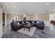 Cozy living area with dark brown sectional, accent pillows, and unique tile flooring at 1005 Cromwell Cv, Snellville, GA 30078