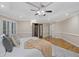 Main bedroom with a tray ceiling, hardwood floors, and decorative pillows on the bed at 1005 Cromwell Cv, Snellville, GA 30078