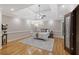 Bright main bedroom features hardwood floors, a ceiling fan, and tray ceiling at 1005 Cromwell Cv, Snellville, GA 30078