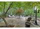 Charming outdoor patio with stone pavers, lounge chairs, and lush landscaping at 1005 Cromwell Cv, Snellville, GA 30078