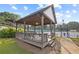 Relaxing spot with wooden pavilion, bench seating and overhead fan next to the community tennis courts at 1005 Cromwell Cv, Snellville, GA 30078