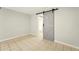 Bedroom features tile flooring and a sliding barn door to a bathroom at 1150 Nw Collier Rd # K24, Atlanta, GA 30318