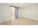 Bright bedroom with tile flooring and a pastel sliding barn door to the en suite bathroom at 1150 Nw Collier Rd # K24, Atlanta, GA 30318
