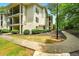 Exterior of a two-story apartment building with private balconies, tidy landscaping, and sidewalks at 1150 Nw Collier Rd # K24, Atlanta, GA 30318