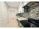 Updated kitchen with modern backsplash, countertops, and stainless steel appliances at 1150 Nw Collier Rd # K24, Atlanta, GA 30318