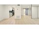 Open concept living room with tile flooring leading to the kitchen and a barn door at 1150 Nw Collier Rd # K24, Atlanta, GA 30318