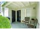 Outdoor patio with seating area including two chairs and a small table adjacent to the front door and greenery at 1150 Nw Collier Rd # K24, Atlanta, GA 30318