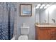Bathroom with vanity, toilet, mirror, granite countertop, and shower with patterned curtain at 151 River Park Cir, Mcdonough, GA 30252