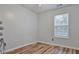 Cozy bedroom featuring hardwood floors, a window, and neutral wall color at 151 River Park Cir, Mcdonough, GA 30252