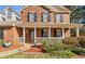A close-up view of a charming brick home's front porch with a welcoming entrance at 151 River Park Cir, Mcdonough, GA 30252