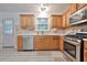 A bright kitchen offers stainless appliances, ample cabinetry, and neutral tiling at 151 River Park Cir, Mcdonough, GA 30252