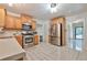 Well-lit kitchen features stainless appliances, light wood cabinets and sleek tile flooring at 151 River Park Cir, Mcdonough, GA 30252