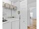 Bright laundry room featuring a washer, dryer, storage baskets, and access to another room at 151 River Park Cir, Mcdonough, GA 30252
