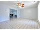 An open-concept living room with tile floors and a view into the dining room at 151 River Park Cir, Mcdonough, GA 30252