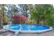 Relaxing backyard featuring an above ground pool with a wooden deck, perfect for summer fun at 151 River Park Cir, Mcdonough, GA 30252