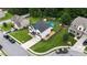 Aerial view of a charming home featuring a well-manicured lawn and a backyard oasis with an above-ground pool at 309 Daffodil Dr, Temple, GA 30179