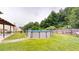 Spacious backyard with a well-maintained lawn and a refreshing above-ground pool, creating an ideal space for outdoor activities and leisure at 309 Daffodil Dr, Temple, GA 30179