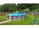 Well-kept backyard featuring a sparkling above-ground pool and manicured lawn, perfect for relaxation and outdoor fun at 309 Daffodil Dr, Temple, GA 30179