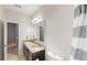 Bathroom featuring a double sink vanity, a large mirror, and a shower-tub combo creating a blend of style and practicality at 309 Daffodil Dr, Temple, GA 30179