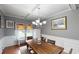 Elegant dining room with coffered ceilings, wainscoting, chandelier, and a wooden table with seating at 309 Daffodil Dr, Temple, GA 30179