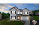 Charming two-story home with a well-manicured lawn and a two-car garage, nestled in a suburban neighborhood at 309 Daffodil Dr, Temple, GA 30179