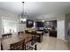 Modern kitchen featuring stainless steel appliances, granite countertops, dark wood cabinets, and a breakfast nook at 309 Daffodil Dr, Temple, GA 30179