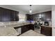Well-equipped kitchen with stainless steel appliances, granite countertops, and ample dark wood cabinetry at 309 Daffodil Dr, Temple, GA 30179