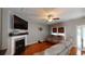 Cozy living room with hardwood floors, a fireplace, TV, and comfortable seating for relaxation at 309 Daffodil Dr, Temple, GA 30179