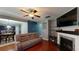 Open-concept living room with hardwood floors, a fireplace, and a view into the adjacent kitchen and dining area at 309 Daffodil Dr, Temple, GA 30179