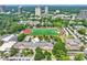 Aerial view featuring a school, sports field, and a vibrant cityscape at 67 Delmont Ne Dr, Atlanta, GA 30305