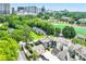Aerial view showcases homes, lush trees, and cityscape in the background at 67 Delmont Ne Dr, Atlanta, GA 30305