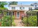 Exterior view of home with fenced backyard and brick patio at 67 Delmont Ne Dr, Atlanta, GA 30305