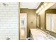 Updated bathroom boasts dual sink vanity, sleek mirrors, and a white-tiled shower at 67 Delmont Ne Dr, Atlanta, GA 30305