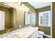 Updated bathroom features marble countertop, dual sinks, and modern lighting at 67 Delmont Ne Dr, Atlanta, GA 30305