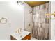Bathroom featuring modern vanity with stylish fixtures and a shower with patterned tile and pebble floor at 67 Delmont Ne Dr, Atlanta, GA 30305