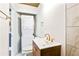 Bathroom featuring a modern vanity, stacked washer/dryer, and gold hardware at 67 Delmont Ne Dr, Atlanta, GA 30305