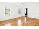 Sunlit bedroom featuring hardwood floors, two windows, and a ceiling fan at 67 Delmont Ne Dr, Atlanta, GA 30305