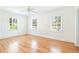 Bright and airy bedroom featuring hardwood floors, neutral paint, ceiling fan, and plenty of natural light at 67 Delmont Ne Dr, Atlanta, GA 30305