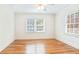 Bedroom features hardwood floors, ceiling fan, and two large windows at 67 Delmont Ne Dr, Atlanta, GA 30305